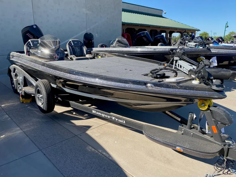 The Image of 2023 Ranger Z521R bass boat on trailer, parked outdoors. - 0