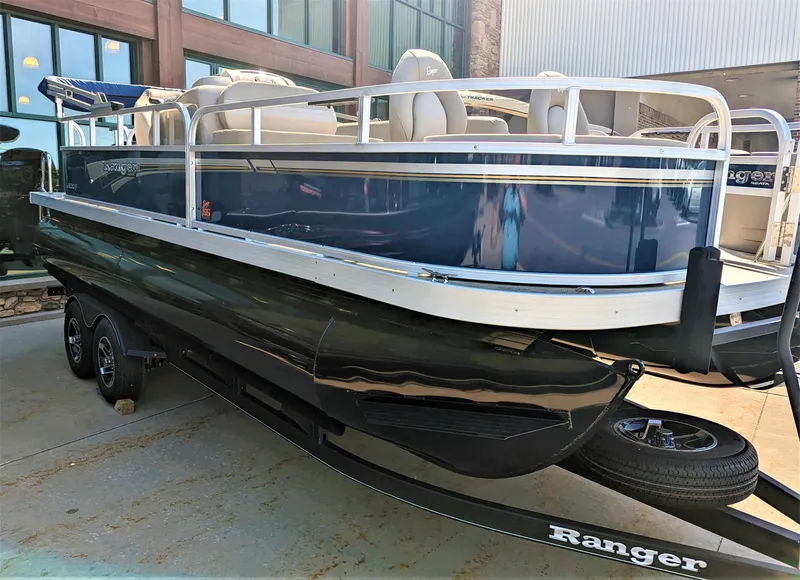 The Image of 2023 Ranger Reata 200F pontoon boat on trailer, parked outdoors. - 0