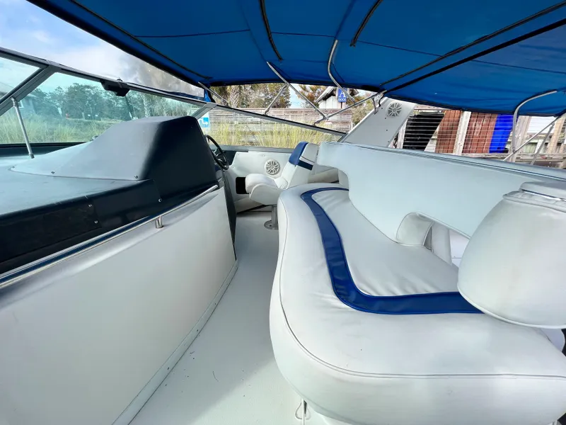 Slide: The Image of Interior of 1993 Sea Ray 440 Sundancer with blue canopy and white seating. - 10