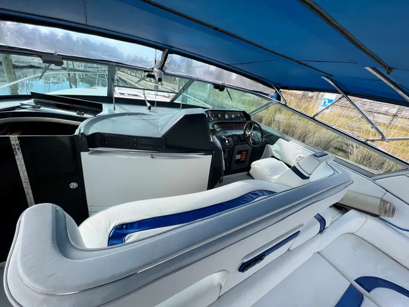Slide: The Image of Interior of a 1993 Sea Ray 440 Sundancer boat with blue and white seating. - 11