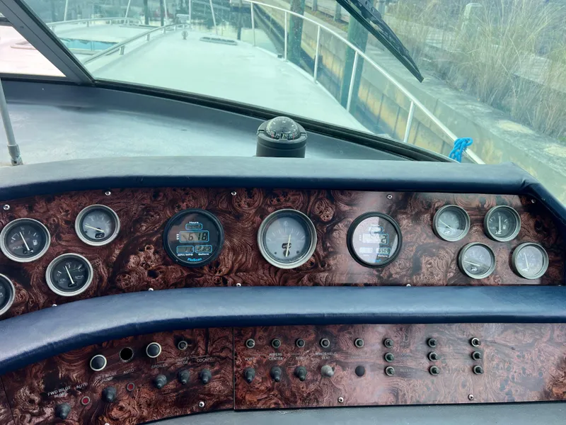Slide: The Image of Dashboard of a 1993 Sea Ray 440 Sundancer boat with gauges and controls. - 15