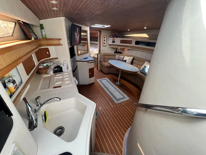 Slide: The Image of Interior of 1993 Sea Ray 440 Sundancer yacht with kitchen and seating area. - 17
