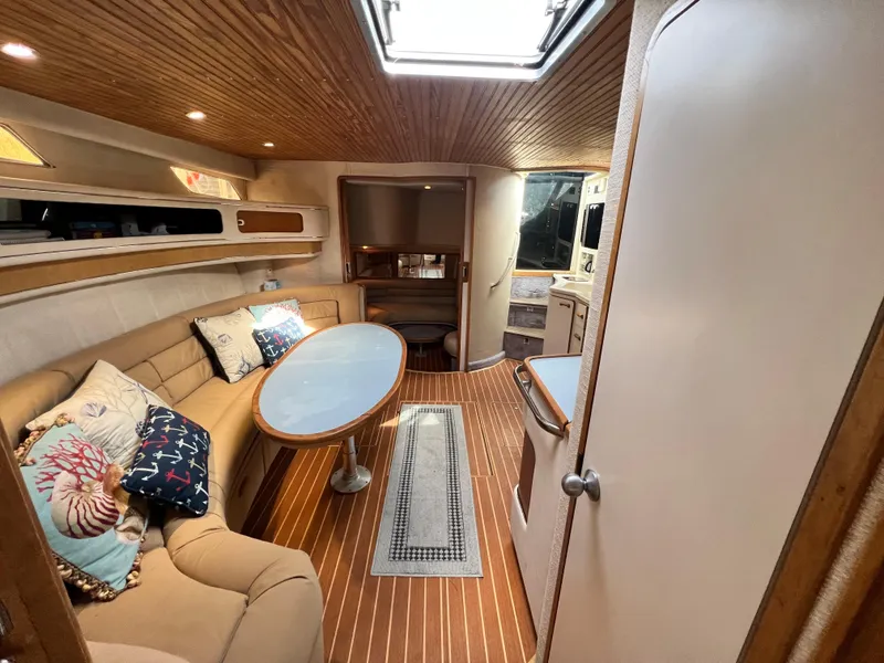Slide: The Image of Interior of 1993 Sea Ray 440 Sundancer yacht with cozy seating and wooden accents. - 20