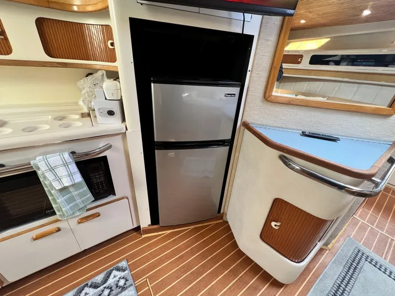 Slide: The Image of Interior of a 1993 Sea Ray 440 Sundancer yacht with kitchen and refrigerator. - 22