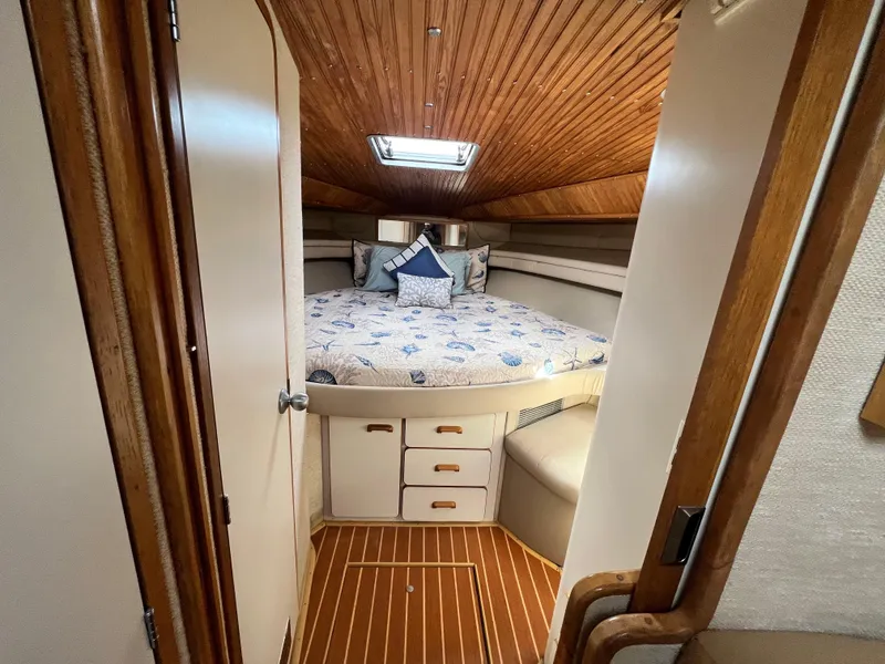 Slide: The Image of 1993 Sea Ray 440 Sundancer cabin interior with bed and wooden ceiling - 25