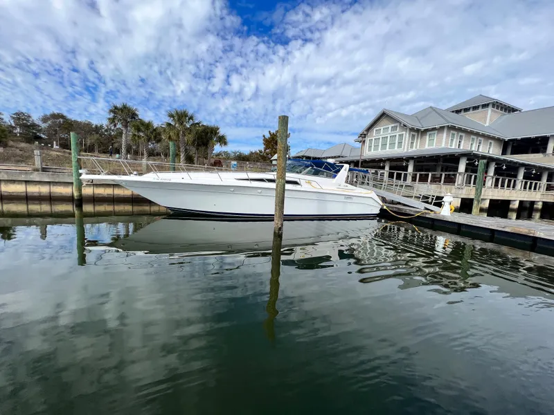 Slide: The Image of 1993 Sea Ray 440 Sundancer docked at marina with blue sky. - 3