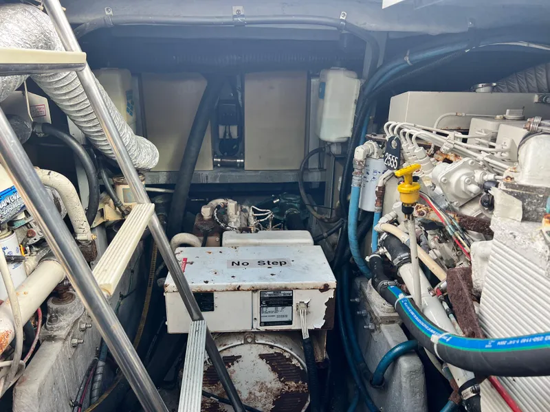 Slide: The Image of Engine room of a 1993 Sea Ray 440 Sundancer boat with visible machinery. - 35