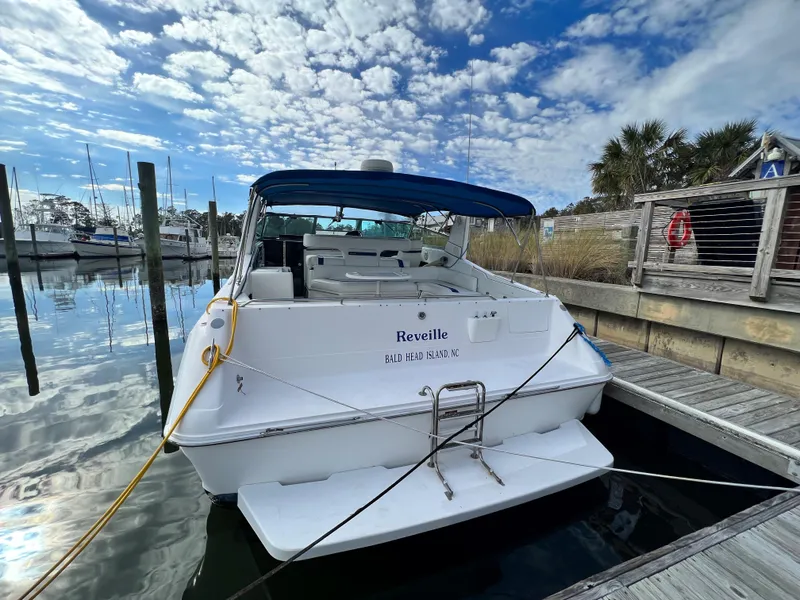 Slide: The Image of 1993 Sea Ray 440 Sundancer docked at a marina under a blue sky. - 5