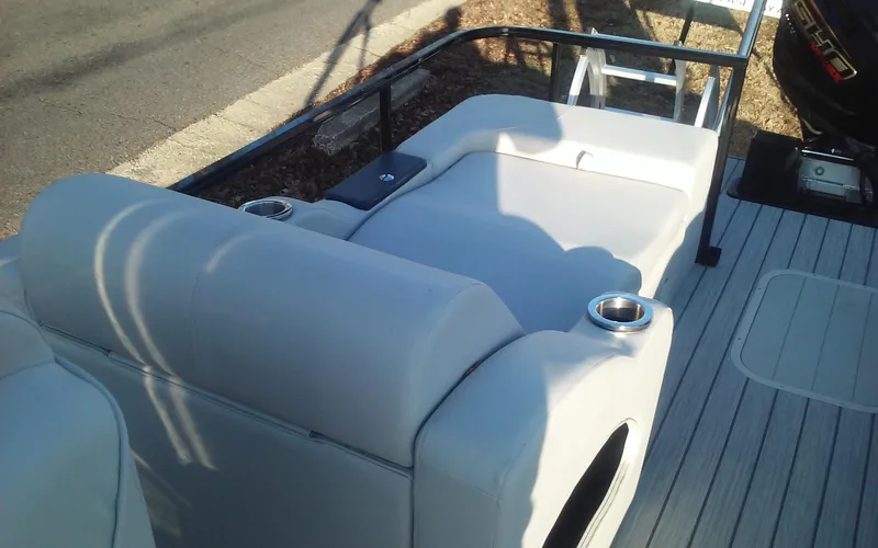 Slide: The Image of 2023 SunCatcher Fusion 324 SS boat interior with white seating and cup holders. - 15