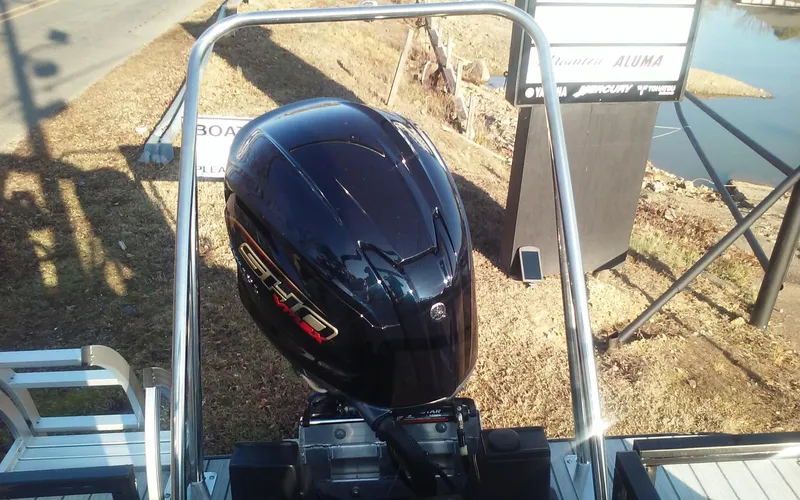 Slide: The Image of 2023 SunCatcher Fusion 324 SS boat with powerful outboard motor, docked near a waterway. - 16