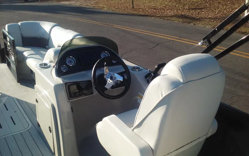 Slide: The Image of 2023 SunCatcher Fusion 324 SS boat interior with white seating and steering console. - 20