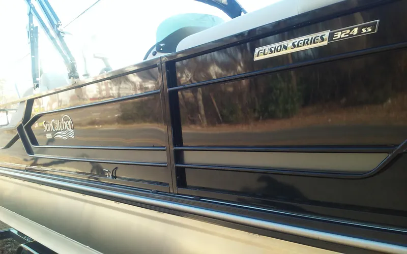 Slide: The Image of 2023 SunCatcher Fusion 324 SS boat, sleek black exterior, side view. - 3