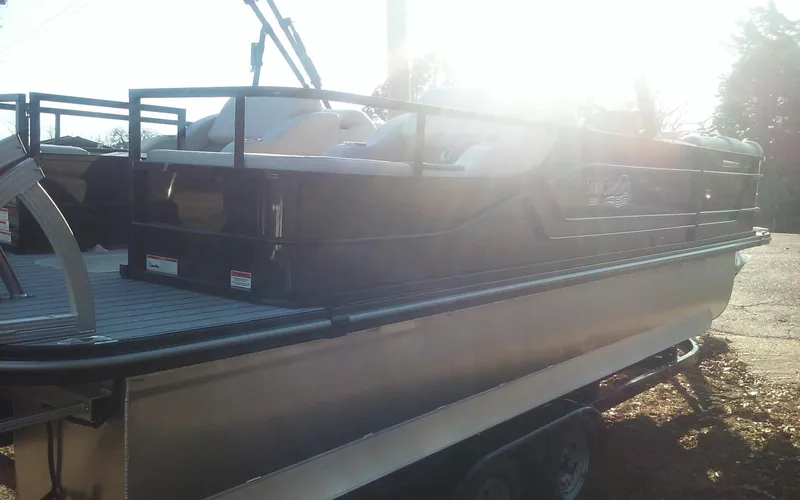Slide: The Image of 2023 SunCatcher Fusion 324 SS pontoon boat on trailer, side view in sunlight. - 4
