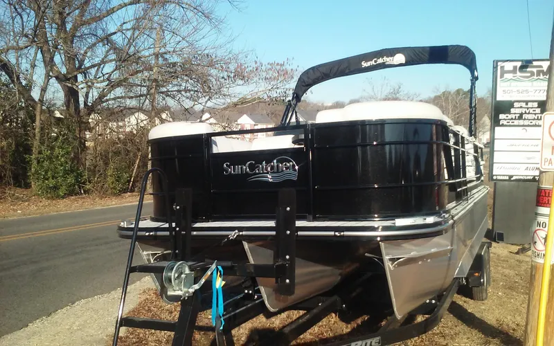 Slide: The Image of 2023 SunCatcher Fusion 324 SS pontoon boat on trailer, parked roadside. - 9