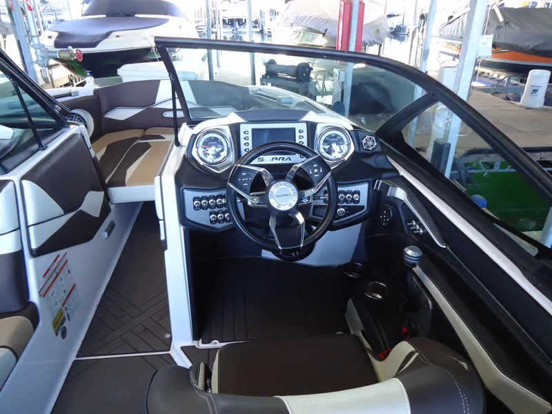 Slide: The Image of 2018 Supra SL boat interior with modern dashboard and steering wheel. - 14