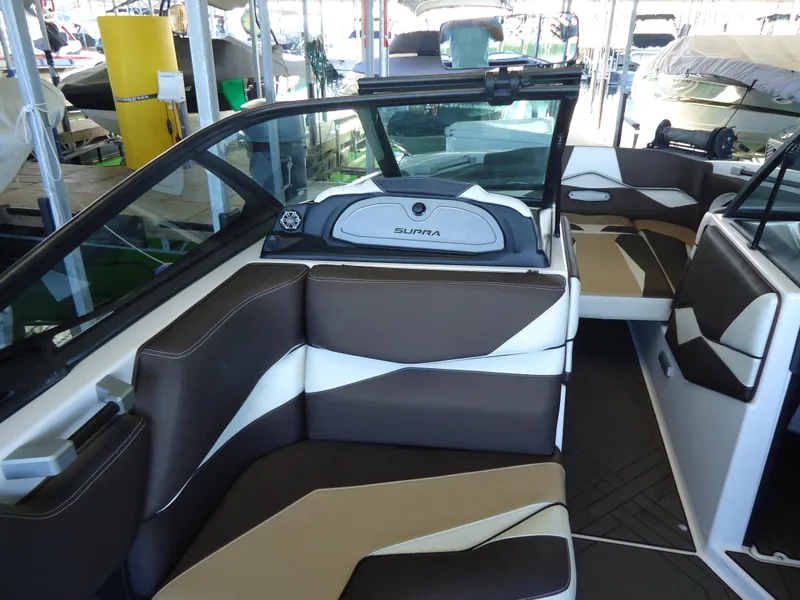 Slide: The Image of 2018 Supra SL boat interior with brown and white seating. - 15