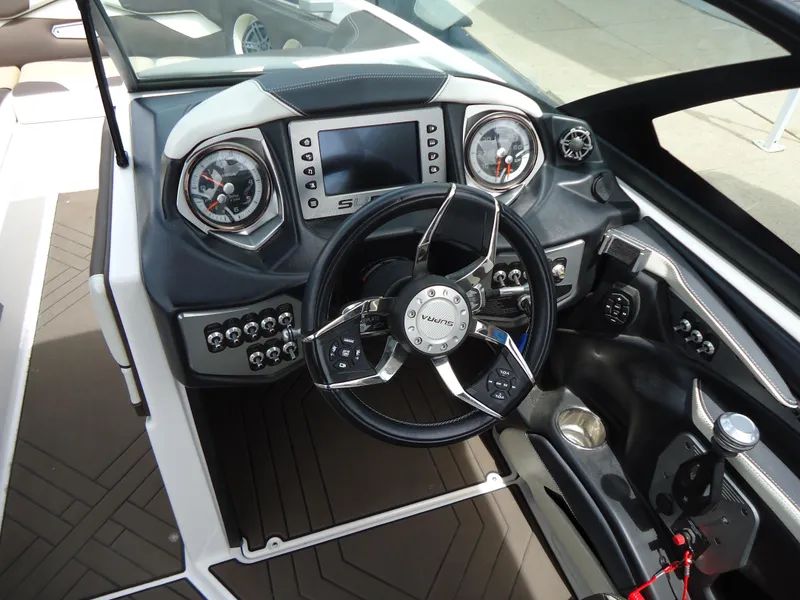Slide: The Image of 2018 Supra SL boat dashboard with steering wheel and control panel. - 21