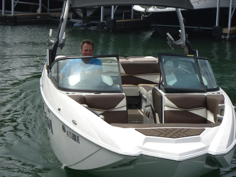 Slide: The Image of 2018 Supra SL boat on water with driver. - 22