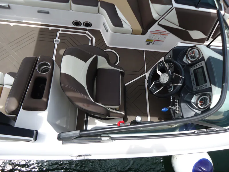 Slide: The Image of 2018 Supra SL boat interior with captain's chair and dashboard. - 24