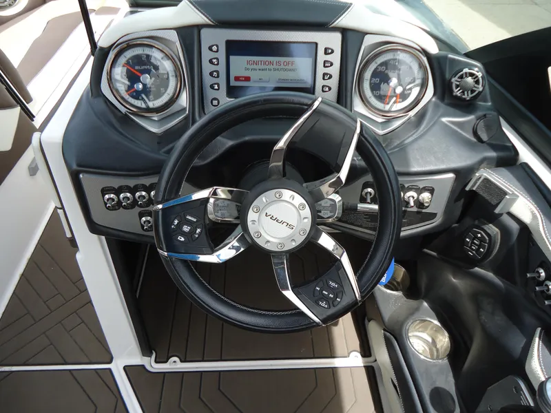 Slide: The Image of 2018 Supra SL boat dashboard with steering wheel and control panel. - 27