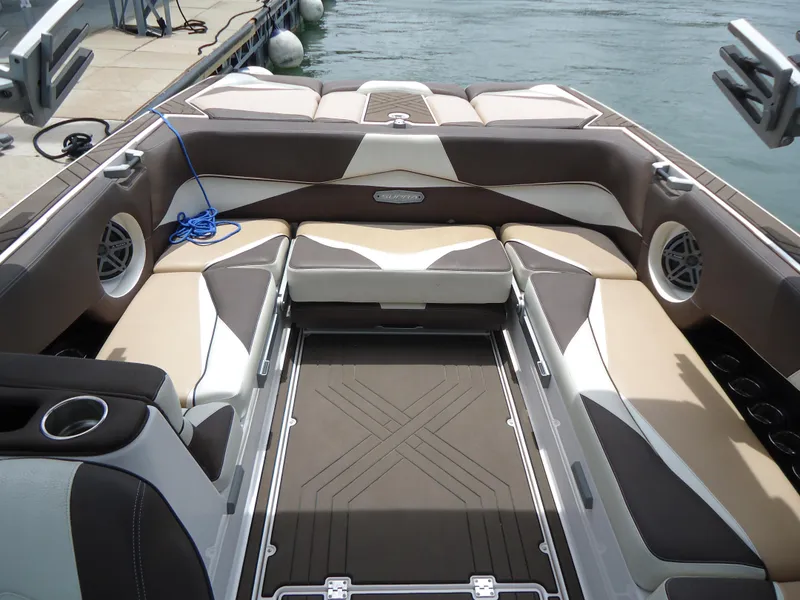 Slide: The Image of 2018 Supra SL boat interior with cushioned seating and cup holders. - 28
