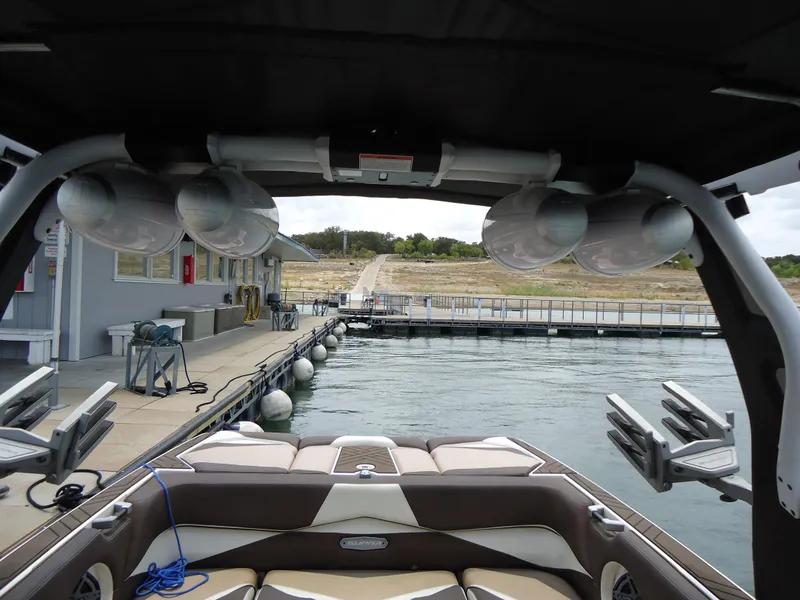Slide: The Image of 2018 Supra SL boat docked at marina with speakers and seating visible. - 29