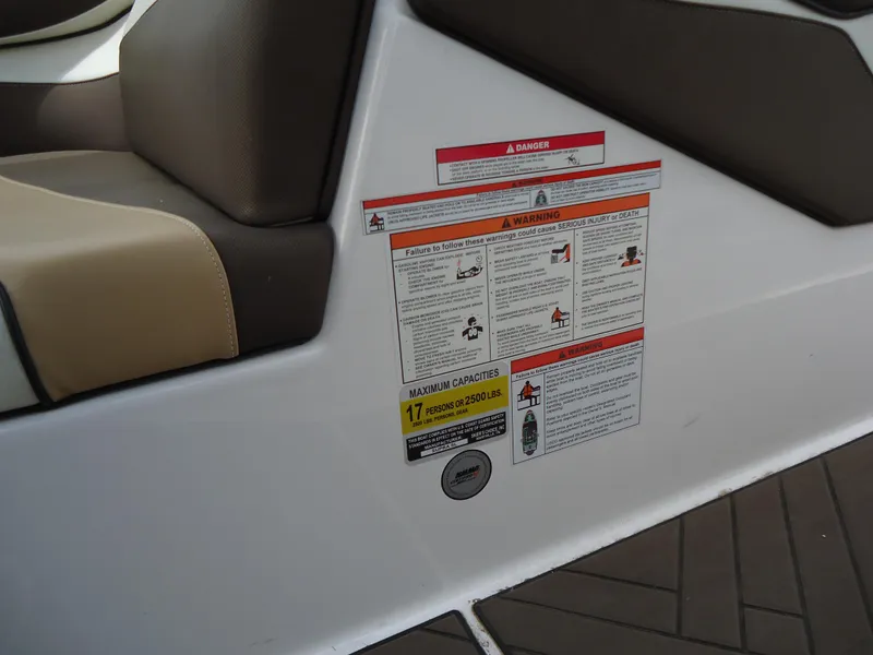 Slide: The Image of Warning labels on 2018 Supra SL boat interior near seat. - 31