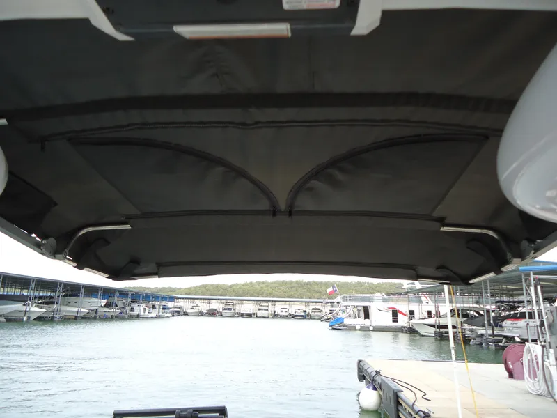 Slide: The Image of View from a 2018 Supra SL boat under a canopy at a marina. - 35