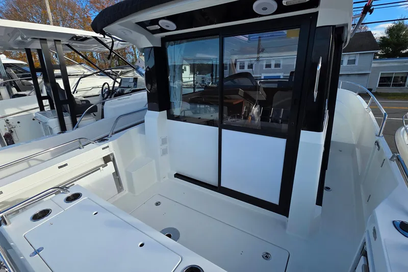 Slide: The Image of 2024 Jeanneau NC 895 Sport boat with sleek design and spacious deck area. - 31