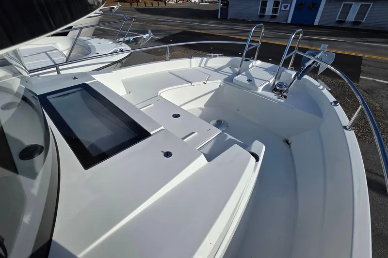 Slide: The Image of 2024 Jeanneau NC 895 Sport boat deck with sleek design and modern features. - 32