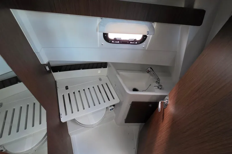 Slide: The Image of 2024 Jeanneau NC 895 Sport interior bathroom with sink and wooden accents. - 36