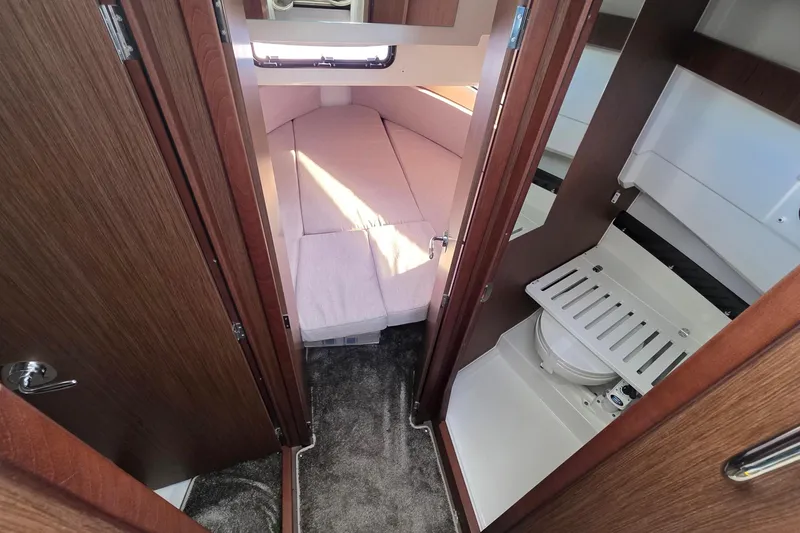 Slide: The Image of 2024 Jeanneau NC 895 Sport cabin interior with bed and compact bathroom. - 37