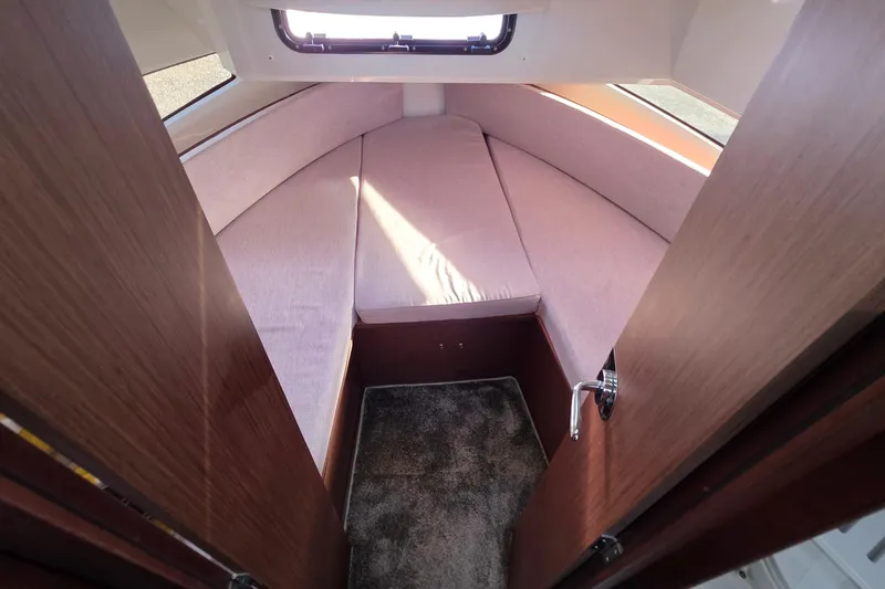 Slide: The Image of 2024 Jeanneau NC 895 Sport cabin interior with cozy bed and window view. - 39