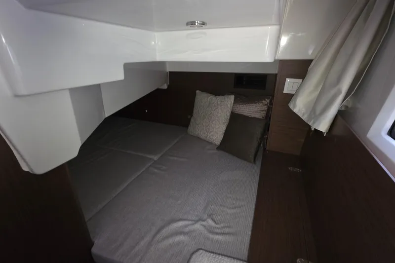 Slide: The Image of 2024 Jeanneau NC 895 Sport cabin interior with cozy bedding and modern design. - 41