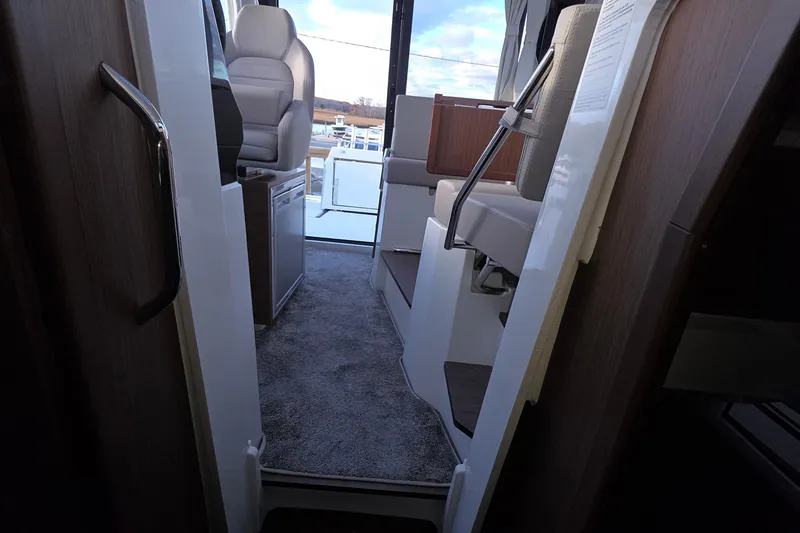 Slide: The Image of 2024 Jeanneau NC 895 Sport interior with seating and helm, showcasing modern design. - 45