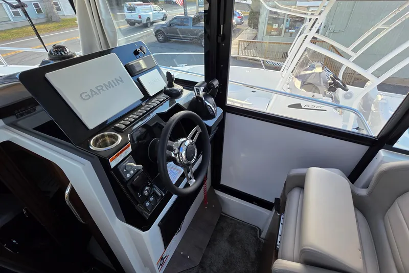 Slide: The Image of 2024 Jeanneau NC 895 Sport helm with Garmin navigation system and comfortable seating. - 49