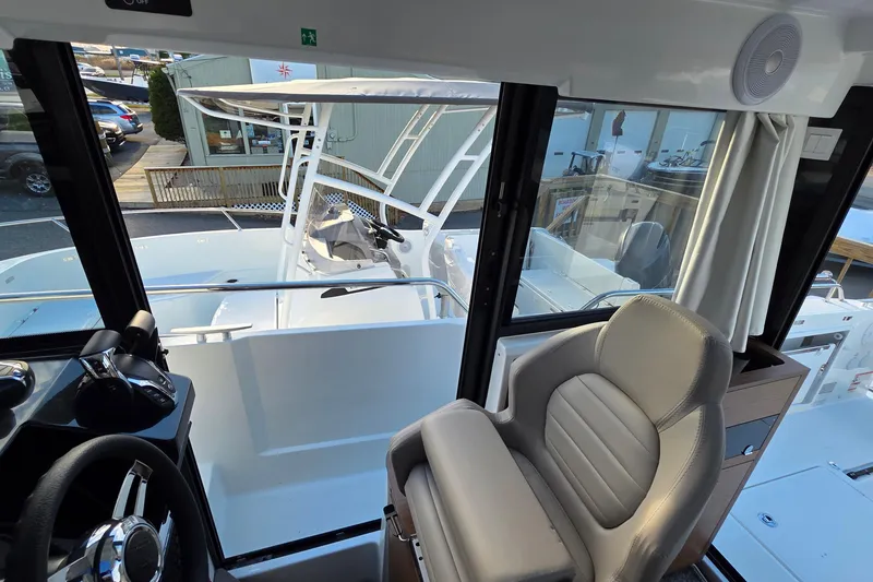 Slide: The Image of Interior view of 2024 Jeanneau NC 895 Sport boat, showcasing helm and seating area. - 53