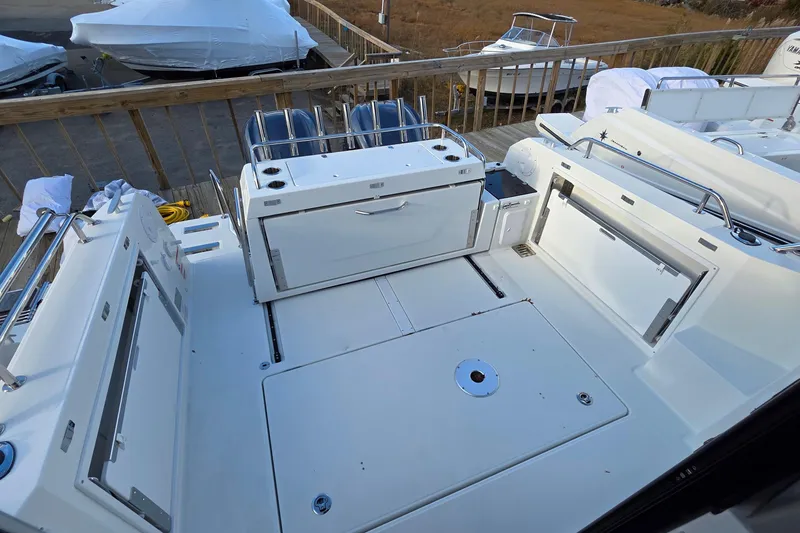 Slide: The Image of 2024 Jeanneau NC 895 Sport boat deck with storage compartments and railing. - 58