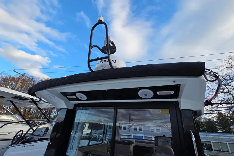 Slide: The Image of 2024 Jeanneau NC 895 Sport boat with Garmin equipment under a blue sky. - 64