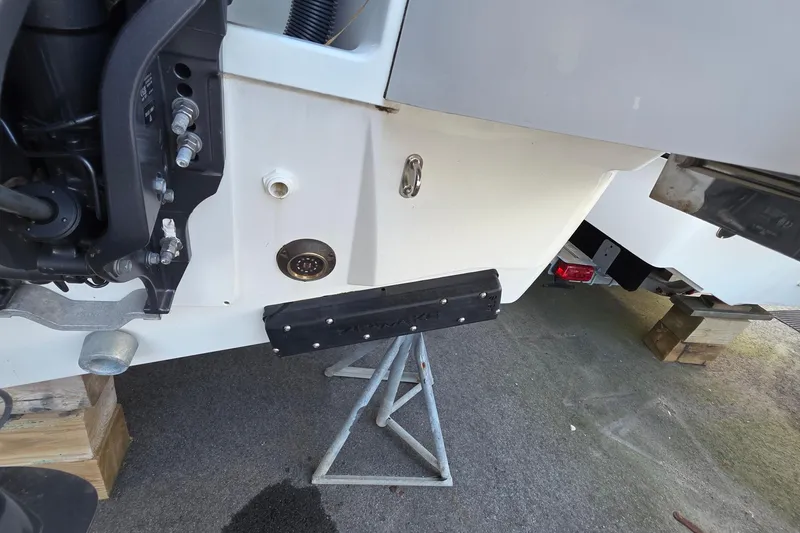 Slide: The Image of 2024 Jeanneau NC 895 Sport boat on stands, showing engine and hull details. - 67