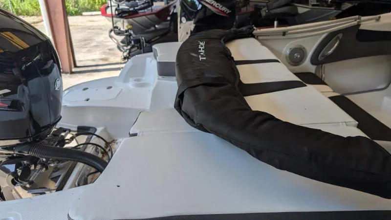 Slide: The Image of 2023 Tahoe 200 S boat interior with engine and protective cover. - 6