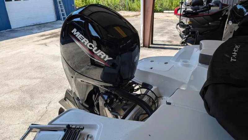 Slide: The Image of 2023 Tahoe 200 S boat with Mercury outboard motor in a garage setting. - 7
