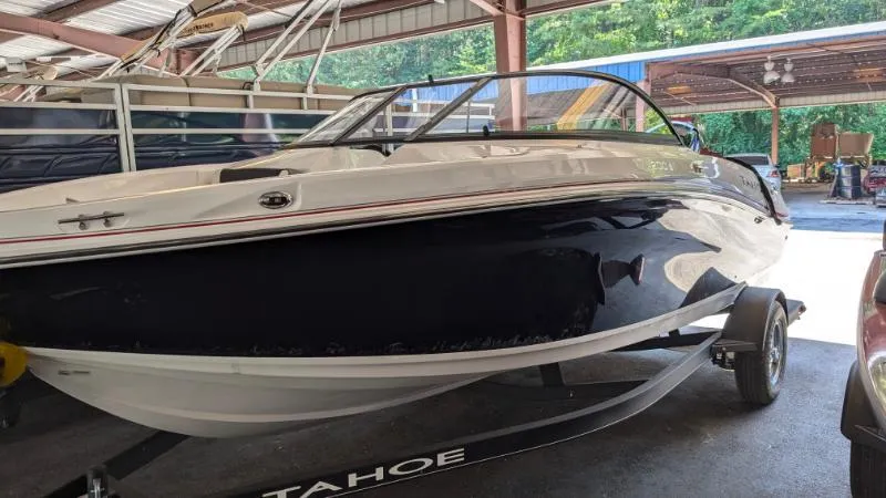 Slide: The Image of 2023 Tahoe 200 S boat in a covered storage area. - 8