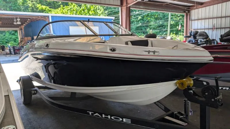 Slide: The Image of 2023 Tahoe 200 S boat in a garage, black and white exterior, on a trailer. - 9