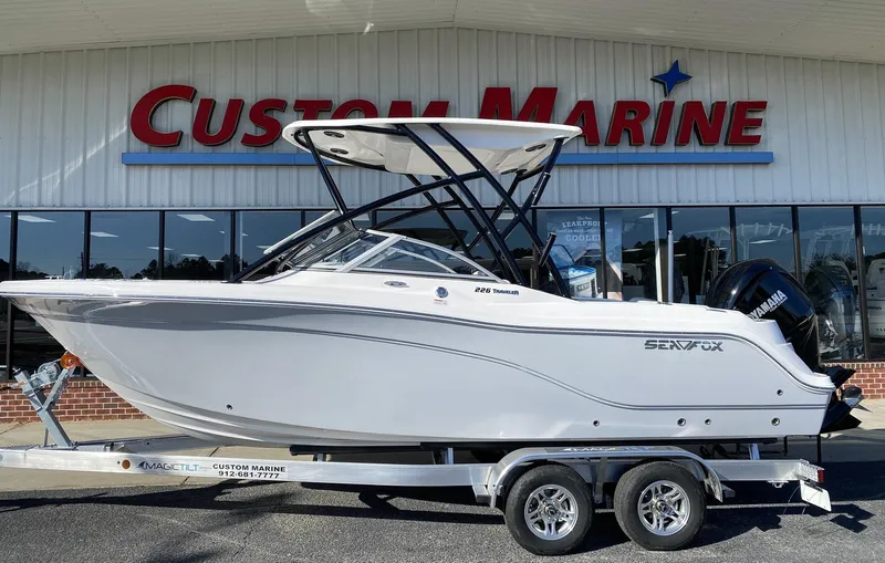 The Image of 2023 Sea Fox 226 Traveler boat on a trailer at Custom Marine dealership. - 1