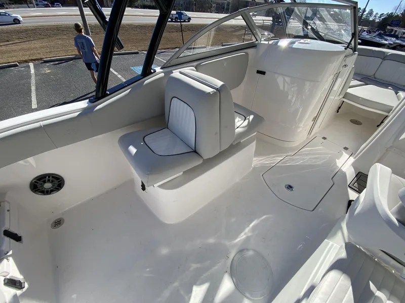Slide: The Image of 2023 Sea Fox 226 Traveler boat interior with white seating and clean deck. - 12
