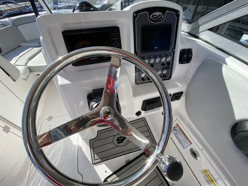 Slide: The Image of 2023 Sea Fox 226 Traveler boat dashboard with steering wheel and control panel. - 14