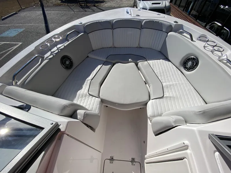 Slide: The Image of 2023 Sea Fox 226 Traveler boat interior with cushioned seating and cup holders. - 16