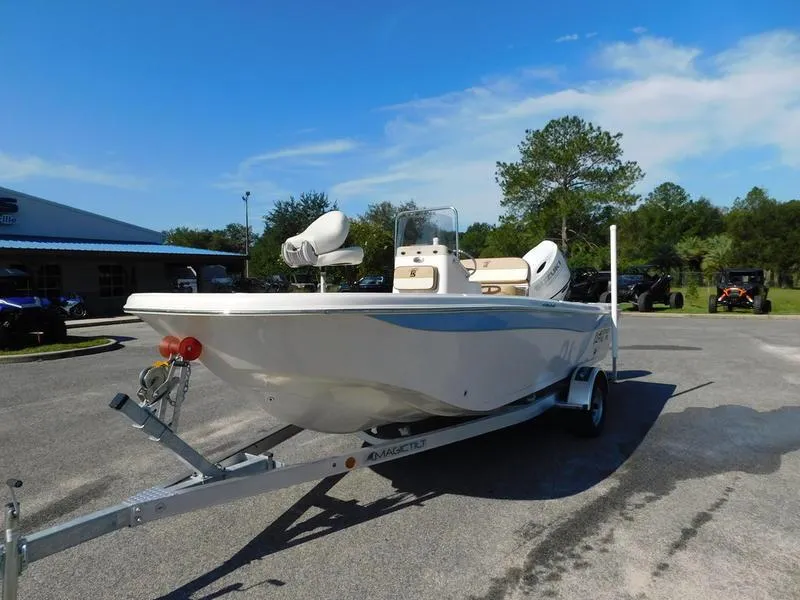 Slide: The Image of 2023 Carolina Skiff 19 Ultra Elite boat on trailer in outdoor lot. - 2