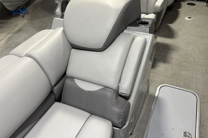 Slide: The Image of 2023 Regency 230 DL3 boat interior with gray cushioned seating and cup holder. - 10